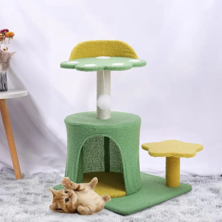 Kitten resting beside a green carpeted cat tree